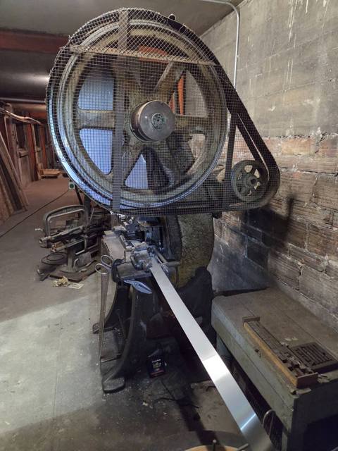 Flywheel, guard and coil strip feed
